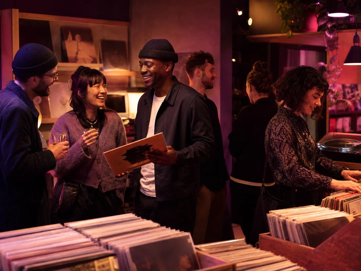 Guests sharing records and conversation at a casual Berlin music night